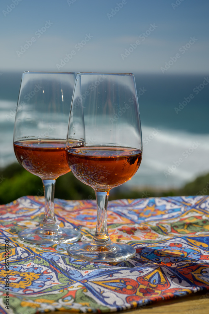 Φωτογραφία Tasting of sweet moscatel de setubal or porto portuguese wine and view on blue A