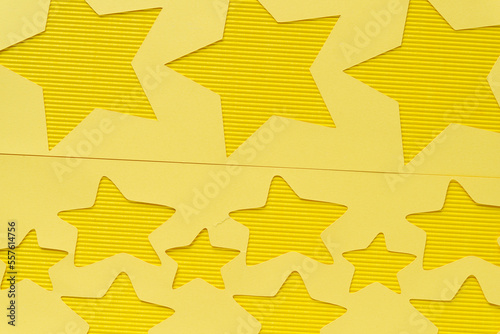 yellow paper stencil with stars on yellow corrugated paper texture