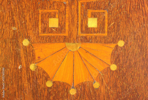 Marquetry fan geometric shape. A common shape for wood decoration. Yellow mother of pearl circles.