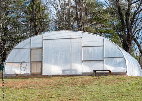 Greenhouse hoop house on a farm with fabric tunnels within the hoop house © JR PIXELS