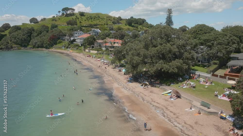 Aerial: Beach-goers at Cheltenham beach, Auckland, New Zealand Aerial: Beach-goers at Cheltenham beach, Auckland, New Zealand