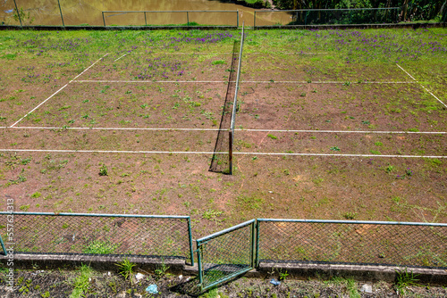 Old abandoned grass tennis court on farm. Countryside of Brazil