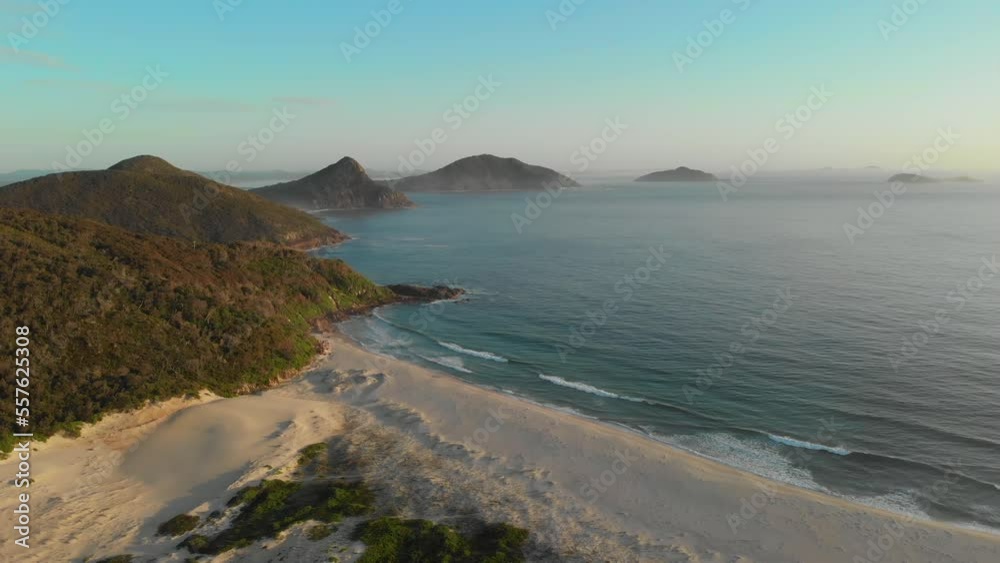 Sunrise drone video of the waves crashing against Fingal beach, facing toward Tomaree Mountain Sunrise drone video of the waves crashing against Fingal beach, facing toward Tomaree Mountain