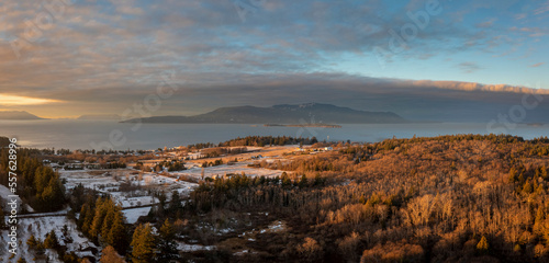Aerial Sunrise View of a Snowy Lummi Island with Orcas Island in the Background. Panoramic look at a winter scene in the San Juan Islands in Washington state.