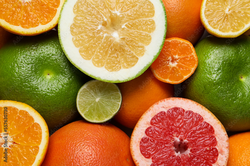 Different fresh whole and cut citrus fruits as background, top view Different fresh whole and cut citrus fruits as background, top view