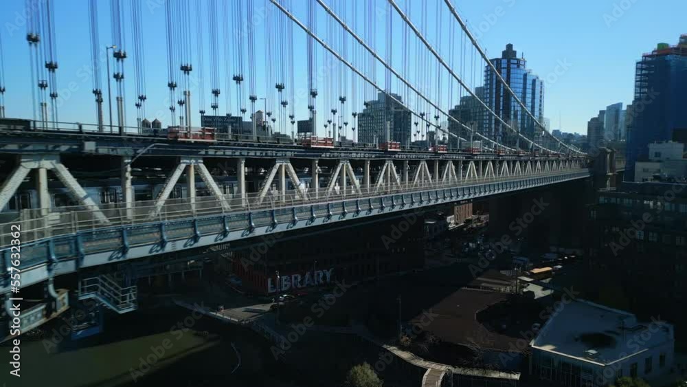 Fly along bridge deck of Manhattan Bridge. Tracking of subway train riding under road. New York City, USA Fly along bridge deck of Manhattan Bridge. Tracking of subway train riding under road. New York City, USA