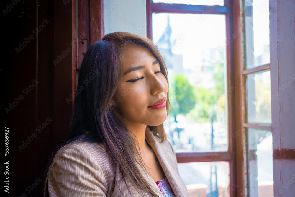 business brunette woman relaxed and happy breathing fresh air in a window business brunette woman relaxed and happy breathing fresh air in a window