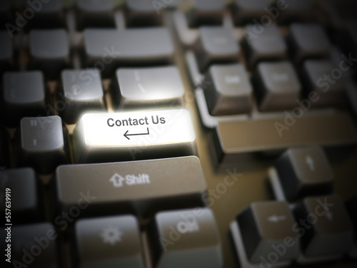 A glowing bright 'contact us' button, key, message on the keyboard. Customer service concept. Internet or online contact for services and businesses.