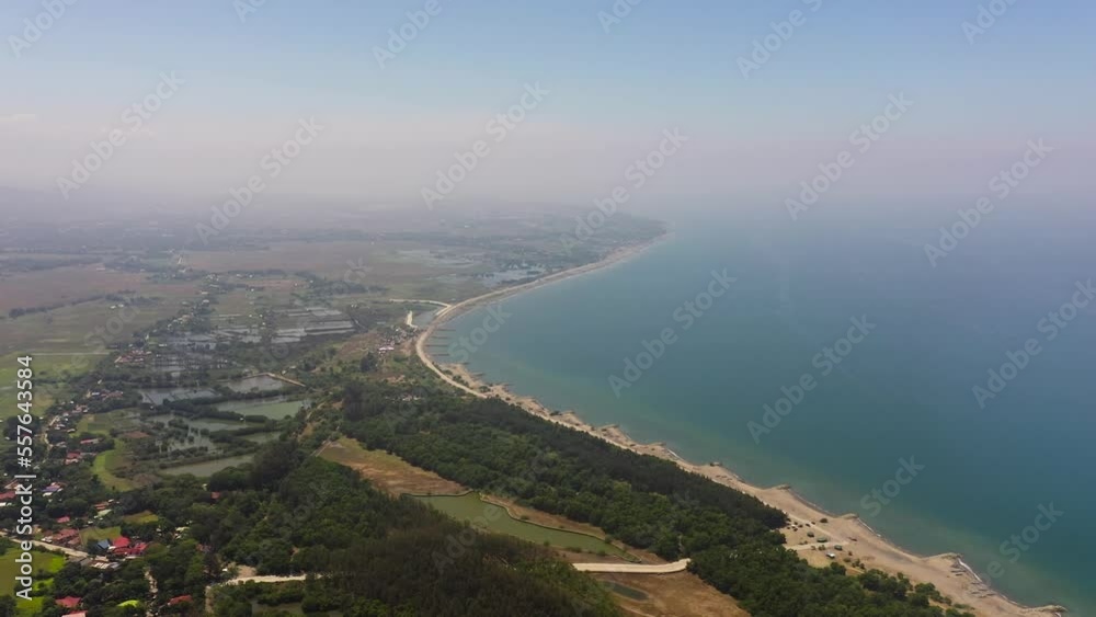Coastline with fishing villages and fish farms view from above. Luzon, Philippines. Coastline with fishing villages and fish farms view from above. Luzon, Philippines.