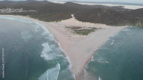 Drone video of the Fingal spit at sunrise, with waves crashing on both sides of the sand bar.
