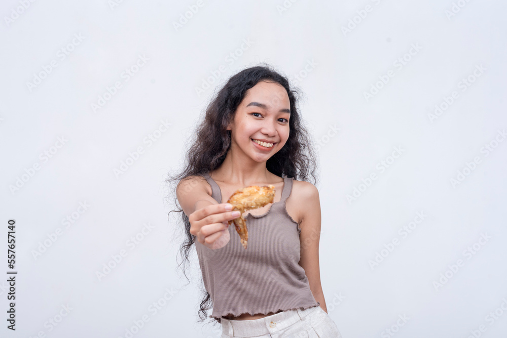 A young perky asian teen offers a tasty chicken wing. Isolated on a light background. A young perky asian teen offers a tasty chicken wing. Isolated on a light background.