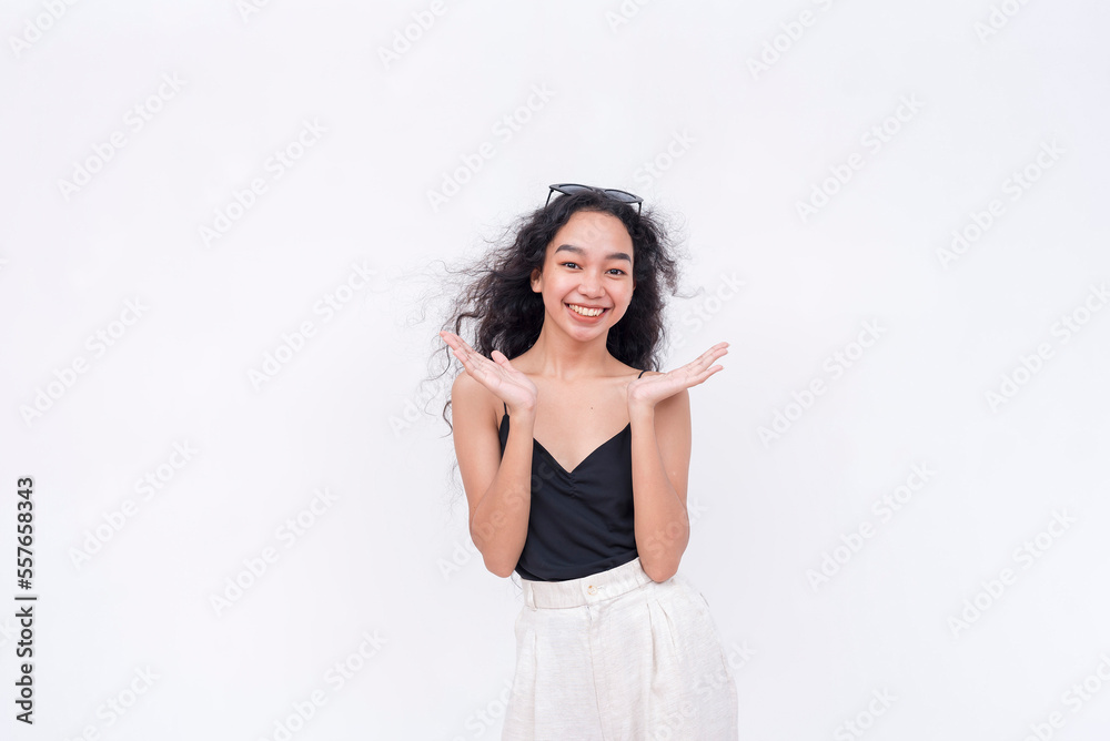 A happy young lady clapping in approval. Wearing a black spaghetti strap blouse. Isolated on a white background. A happy young lady clapping in approval. Wearing a black spaghetti strap blouse. Isolated on a white background.