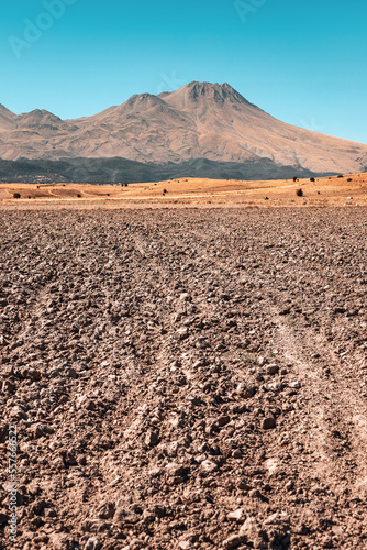 Plowed field and tillage with the extinct volcano Hassan Dag in the background. Agriculture and travel in Turkey photo