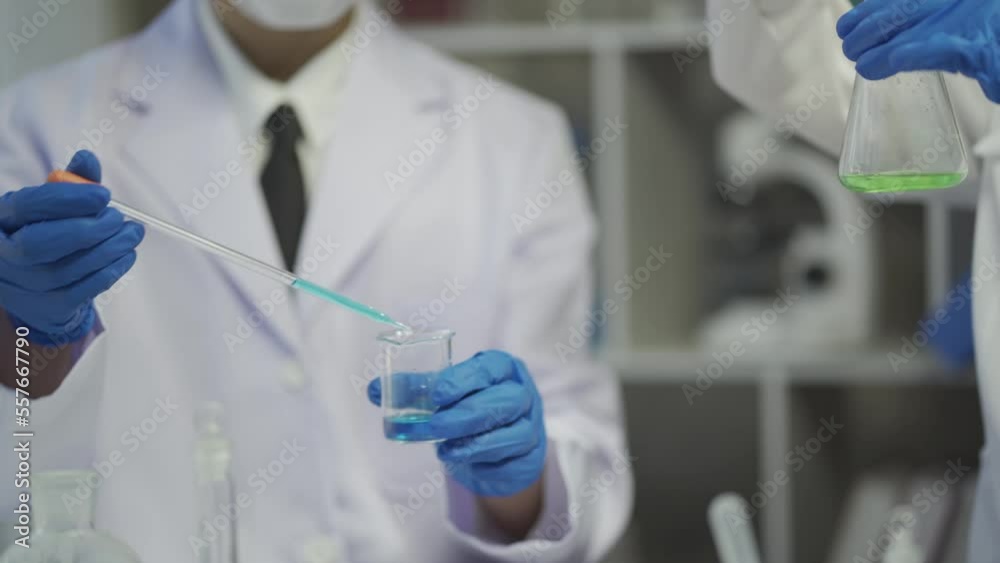 Medical research scientist testing vaccine experimental drug in laboratory The doctor tests the pipette dropper sample with a chemist line in a test tube. Medical research scientist testing vaccine experimental drug in laboratory The doctor tests the pipette dropper sample with a chemist line in a test tube.