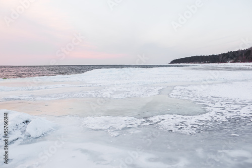 Winter coastal landscape with frozen path next to sea and forest - Saulkrasti, Latvia