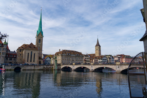 Skyline of the old town of City of Zürich with churches Women's Minster and St. Peter and Limmat River on a blue cloudy autumn day. Photo taken October 30th, 2022, Zurich, Switzerland.