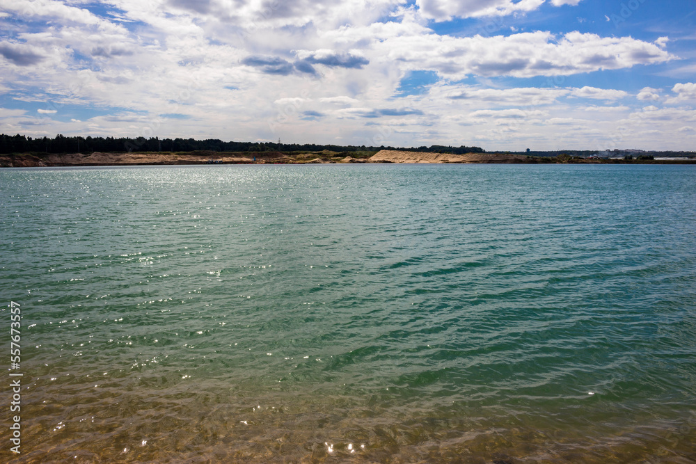 Clear turquoise water on a flooded sand pit Clear turquoise water on a flooded sand pit