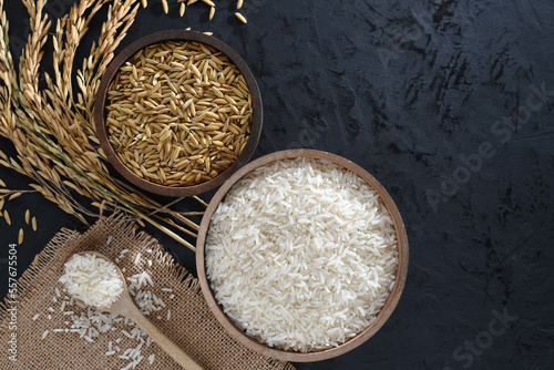 Obraz na płótnie Paddy and rice in baskets placed on a black background with ears of rice. w salonie