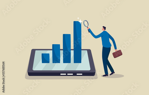 Mobile business analysis and statistic online services. Key performance indicator to evaluate success. Businessman analyst holding magnifying glass analyze graph and chart on smartphone.
