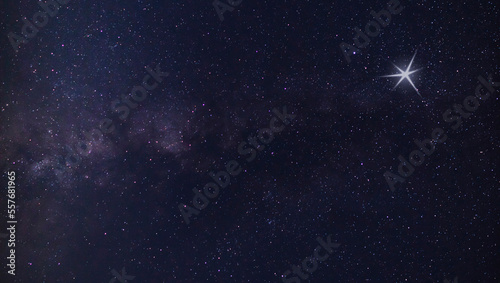 Obraz na płótnie Glowing object in the sky next to the Milky Way that reminds views of a Christmas star w salonie