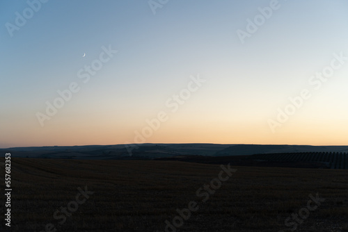 sunset over the field and moon 