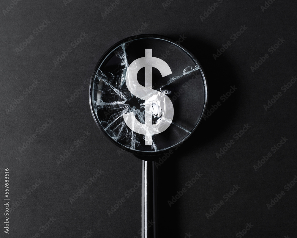Obraz premium Inflation, economic crisis, financial problems, recession concept. Close-up of broken cracked magnifier glass focused on dollar sign on black background