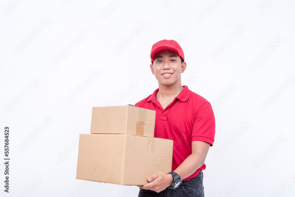 A asian delivery man in a red cap and shirt, carrying two boxes. A courier handling and delivering parcels. Isolated on a white background. A asian delivery man in a red cap and shirt, carrying two boxes. A courier handling and delivering parcels. Isolated on a white background.