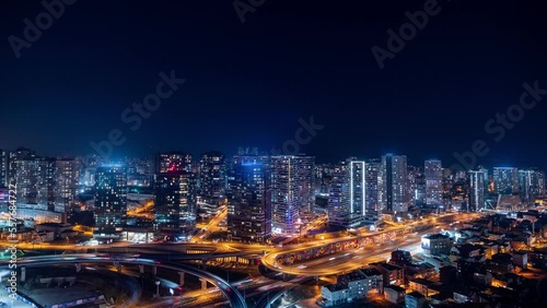 4K UHD timelapse of car traffic and people crossing road at night in Istanbul city downtown. Drone aerial top view, fly upward. Commuter, Europe city life or public transportation concept stock video.