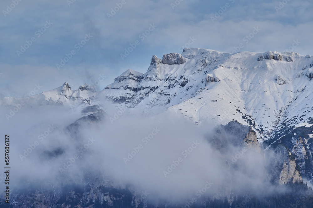 Landscape image of mountain top covered by snow and clouds Landscape image of mountain top covered by snow and clouds