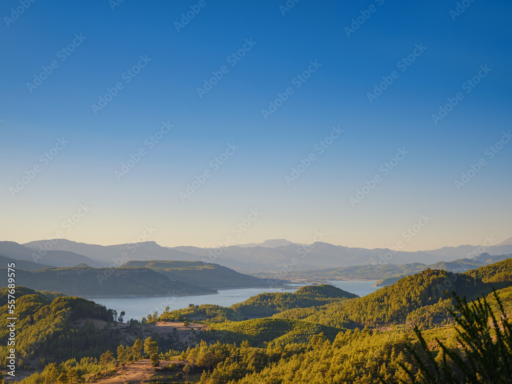 Turkey travel, mediterranean area on a warm summer day. Karacaoren lake and mountains aerial view landscape