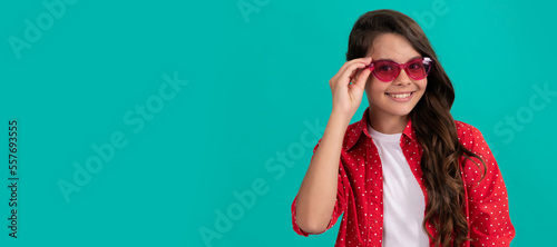 pretty look of young girl. portrait of child casual style on blue background. Child face, horizontal poster, teenager girl isolated portrait, banner with copy space.