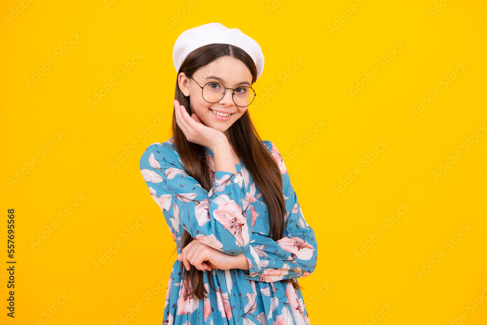 Children studio portrait on yellow background. Childhood lifestyle concept. Cute teenage girl face close up. Happy teenager, positive and smiling emotions.