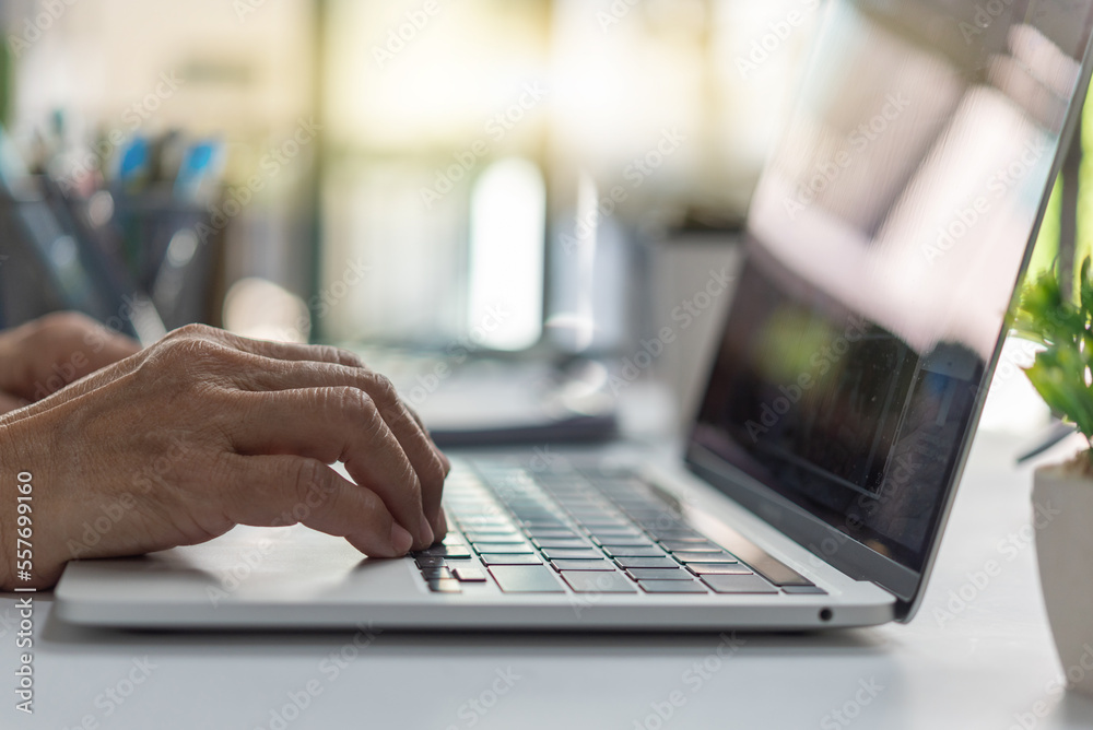 woman working and typing on the keyboard on table at home. woman working and typing on the keyboard on table at home.