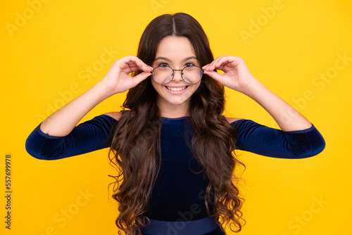 Happy face, positive and smiling emotions of teenager girl. Ophthalmologist tries on eyeglasses of teenager little girl, close-up. Treatment of childrens vision with glasses.