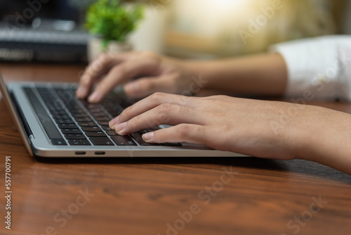 woman working and typing on the keyboard on table at home.