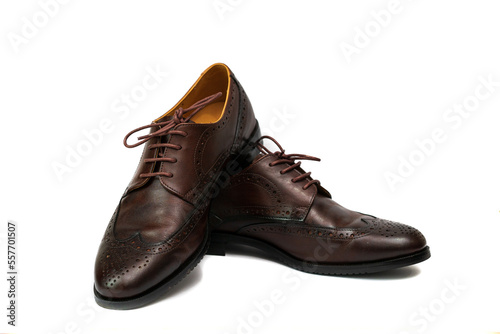 Brown brushed leather shoe with broguing in isolated white background. © MU Studio