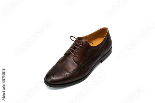 Brown brushed leather shoe with broguing in isolated white background.