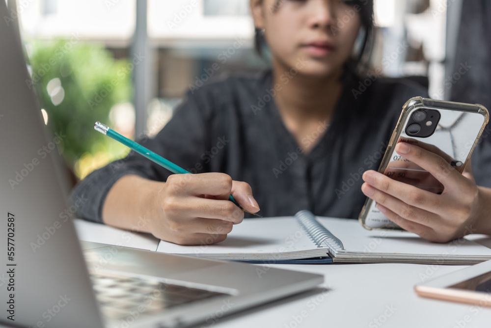 Woman hands with pen writing on notebook in the office.learning, education and work.writes goals, plans, make to do and wish list on desk. Woman hands with pen writing on notebook in the office.learning, education and work.writes goals, plans, make to do and wish list on desk.