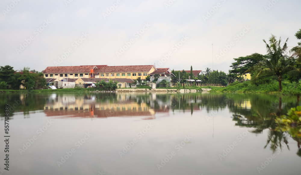 The school building is on the edge of the swamp.