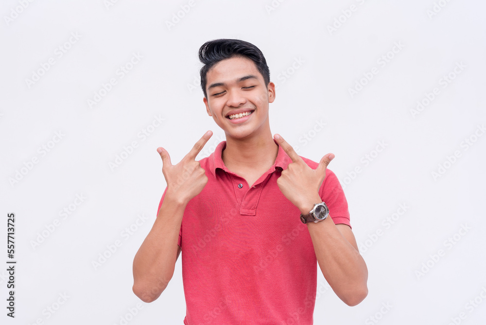 A young handsome asian man feeling blissful about his great teeth. Isolated on a white backdrop. A young handsome asian man feeling blissful about his great teeth. Isolated on a white backdrop.