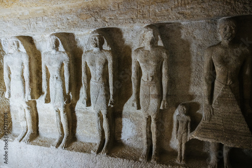 Ancient Egyptian statues in a tomb next the pyramids of Giza in Cairo, Egypt
