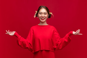 Young asian woman wearing red sweater dress with product presentation on red background for Chinese new year and Christmas festival