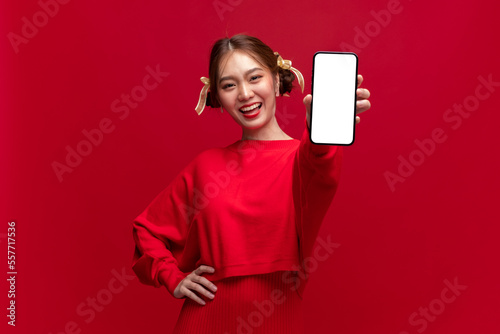 Cuadro en lienzo Young asian woman wearing red sweater dress show smartphone with empty screen on