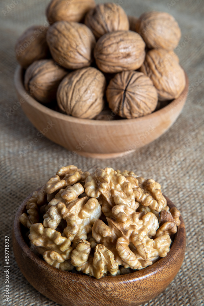 Peeled walnuts and whole walnuts on burlap sack Peeled walnuts and whole walnuts on burlap sack