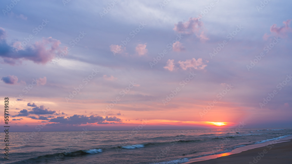 Sunset sky clouds over sea in the morning with orange sunrise, horizon sea beach landscape 