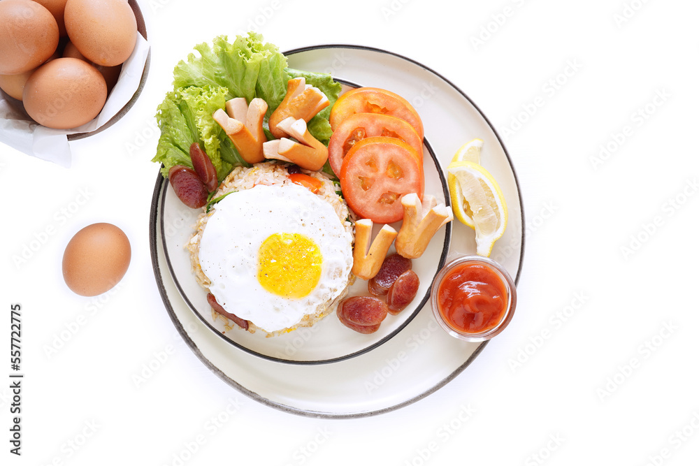 Fried rice and hot dogs, cooked fried egg, Chinese sausage and ketchup on a white background. Fried rice and hot dogs, cooked fried egg, Chinese sausage and ketchup on a white background.
