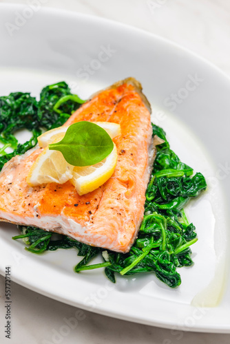grilled salmon fillet with spinach leaves salad