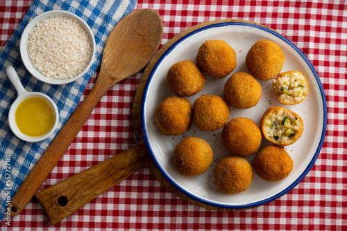 Arancini are a specialty of Sicilian cuisine. They are stuffed breaded and fried rice balls or cones.