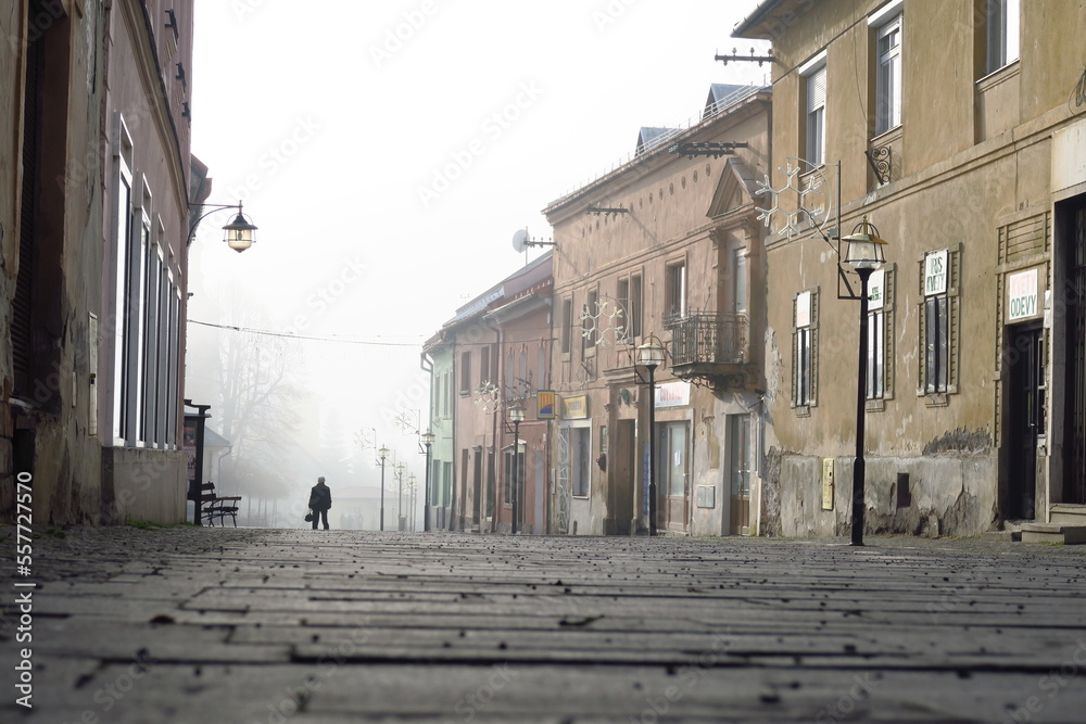 villiage and city center street of kremnica in slovakia in winter with fog