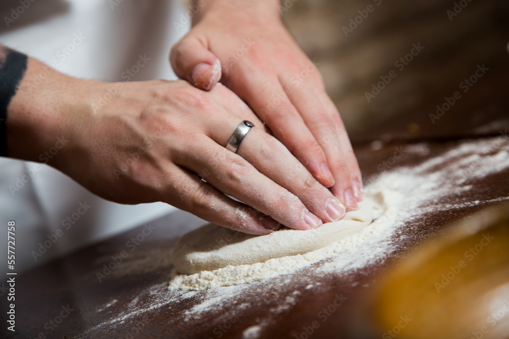 Preparing the dough for a Neapolitan pizza with tomato and cheese. Preparing the dough for a Neapolitan pizza with tomato and cheese.